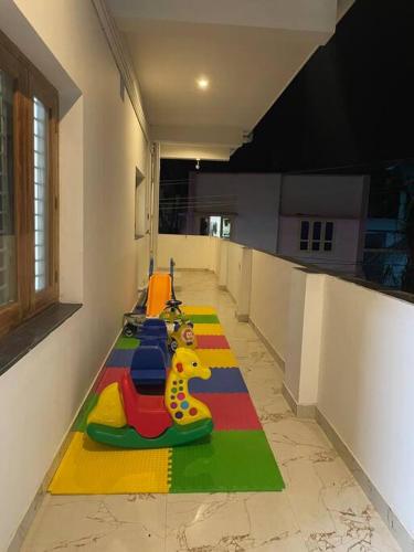a room with a long line of toys on the floor at White Home Stay in Kanyakumari