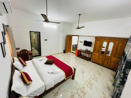a bedroom with a large bed in a room at White Home Stay in Kanyakumari