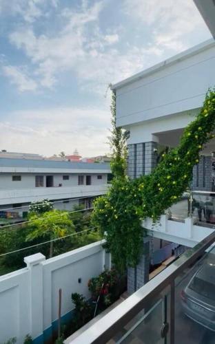 a view of a balcony of a building with plants at White Home Stay in Kanyakumari