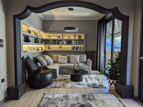 a living room with a couch and a table at Be My Guest Athens in Athens