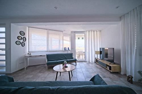 a living room with a couch and a table at Apartment Afitojen in Postira