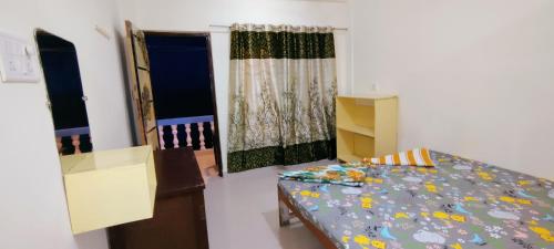 a small room with a bed and a window at Shree Sai Beach Stay in Arambol