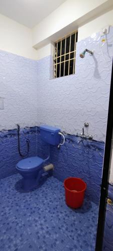a bathroom with a blue toilet and a shower at Shree Sai Beach Stay in Arambol