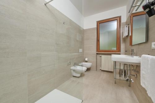a bathroom with a toilet and a sink at Casa Milani in Malcesine