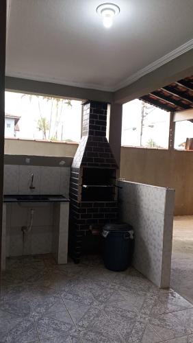 a pizza oven sitting inside of a building at Casa de praia in Bertioga