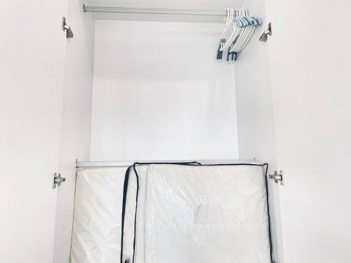 a room with a white shower curtain and lights at Mutiara Melaka Beach Resort by Glex in Tangga Batu