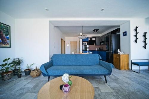 a living room with a blue couch and a table at Apartment Afitojen in Postira