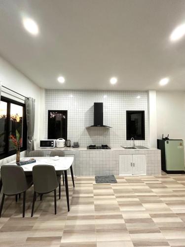 a kitchen with a table and chairs in a room at Cozy Vazn House Krabi Klong Muang in Ban Khao Klom