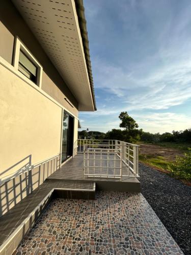 a porch of a building with a fence on it at Cozy Vazn House Krabi Klong Muang in Ban Khao Klom