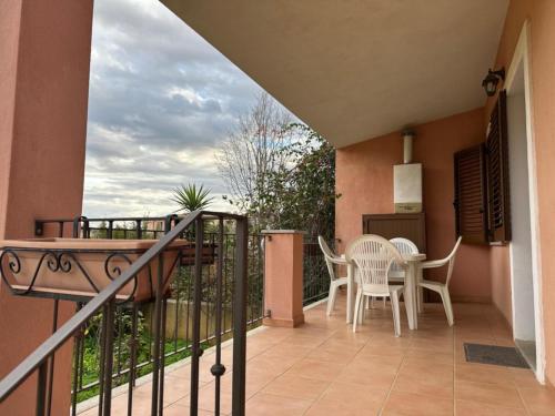 a balcony with a table and chairs on it at Villa Samuele - Porto Frailis in Àrbatax