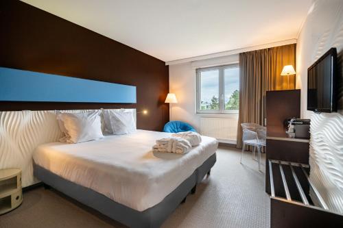 Postel nebo postele na pokoji v ubytování Hotel L'Europe