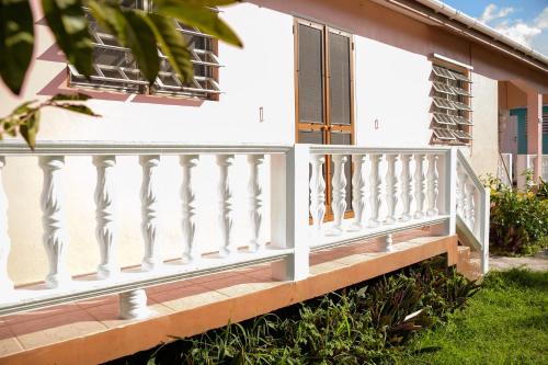 a white railing on a porch of a house at Good Times in Gingerland