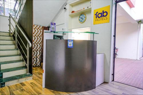 a lift in a building with a clock on the wall at FabHotel Diamond Stay in Pune