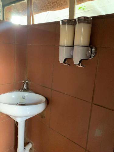 a bathroom with a sink and a mirror on the wall at Sunset Guesthouse and Venue Cullinan in Meule