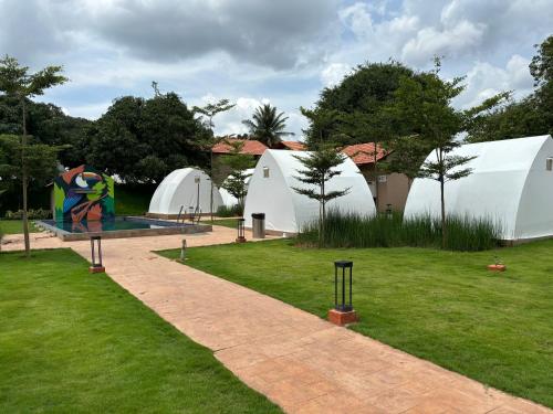 a park with white domes and a swimming pool at Ravishing Retreat Resort in Rāmanagaram