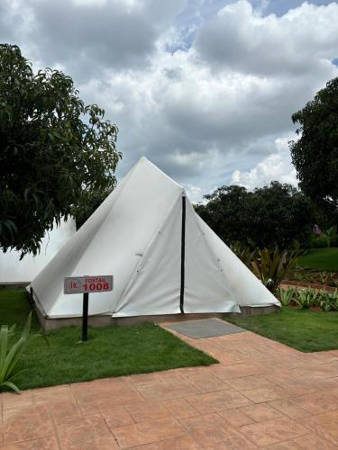 a large white tent sitting on the grass at Ravishing Retreat Resort in Rāmanagaram