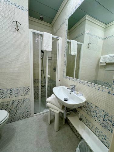 a bathroom with a sink and a shower at Olivi Hotel & Natural Spa in Sirmione