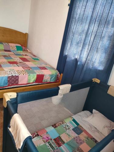 a bedroom with two bunk beds and a window at Casa da Matilde in Fajã de São João