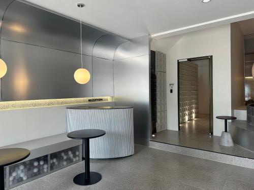 a lobby with two stools and a counter in a building at Lune bangkok in Bangna
