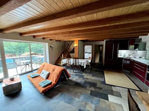 a large living room with a couch and a kitchen at Obermühle Heideland in Heideland