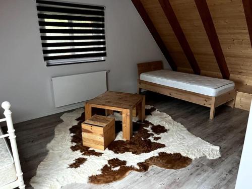 a bedroom with a bed and a table and a rug at Obermühle Heideland in Heideland