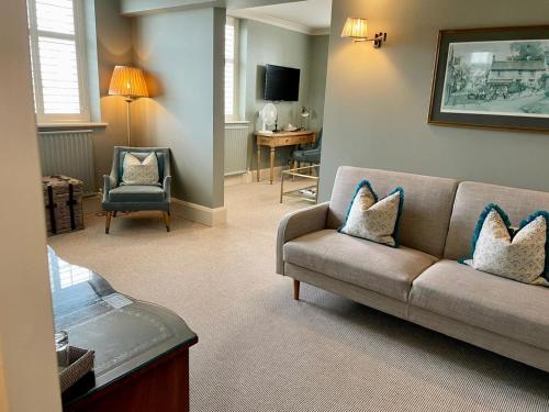 a living room with a couch and a table at Castle Hotel in Taunton