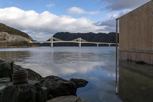a bridge over a river with a large body of water at ELSUENITOhinase in Hinase