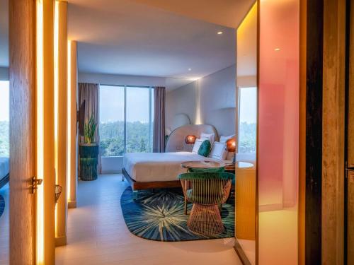 a hotel room with a bed and a table at Gem Forest Hotel Nairobi - MGallery Collection in Nairobi