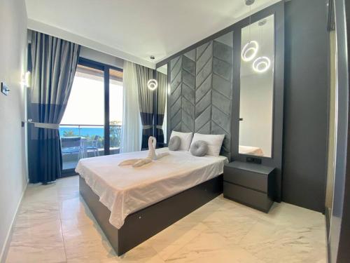 a bedroom with a bed and a large window at Via Mar Residence - Alanya Experience in Alanya