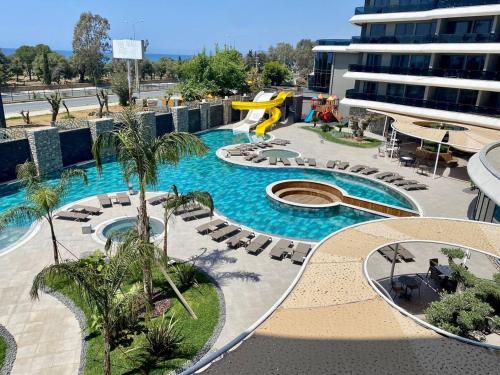 a swimming pool with a slide in a resort at Via Mar Residence - Alanya Experience in Alanya
