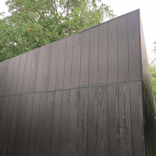 a black fence with trees in the background at A Leira 116 Cabañas de diseño in Sarria