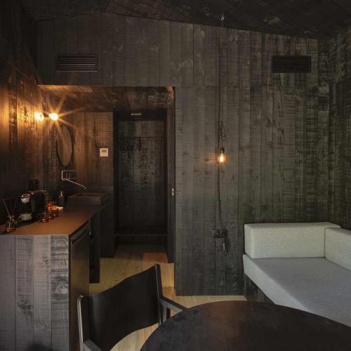 a living room with a couch and a table at A Leira 116 Cabañas de diseño in Sarria