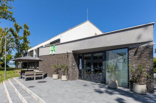a building with a patio in front of it at NEKA Village in Balatonboglár