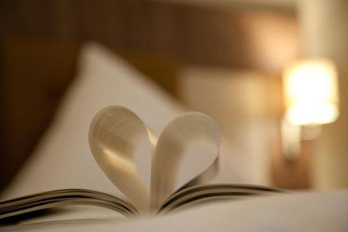 an open book with two pages forming a heart at Hotel am Wald in Bad Tölz