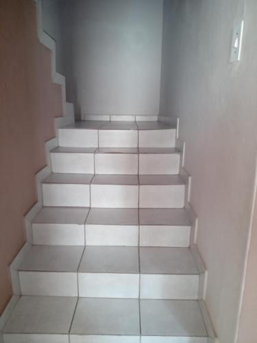 a staircase in a room with white walls at Majestic Haven Guesthouse in Mabopane