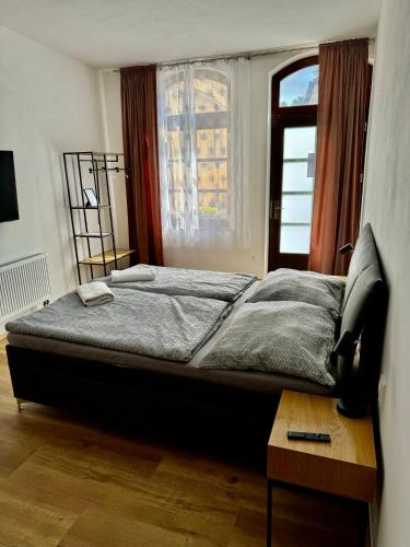 a bedroom with a large bed with a window at Ubytování U Pivovaru in Kamenice nad Lipou