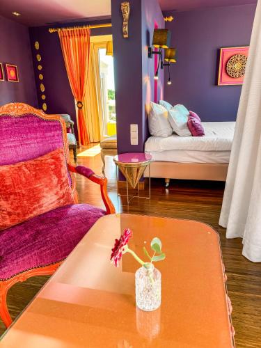 a living room with a table and a bed at Boutique Hotel Vivenda Miranda in Lagos