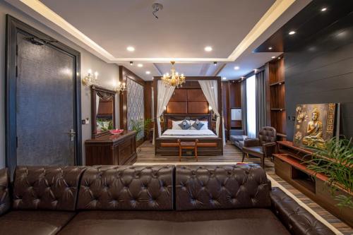 a living room with a couch and a bed at Hotel Adhiraja palace in Haridwār