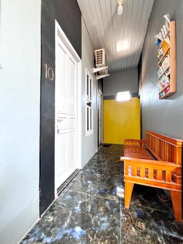 a hallway with a bench and a door at Kost Harian Semarang Murah in Semarang