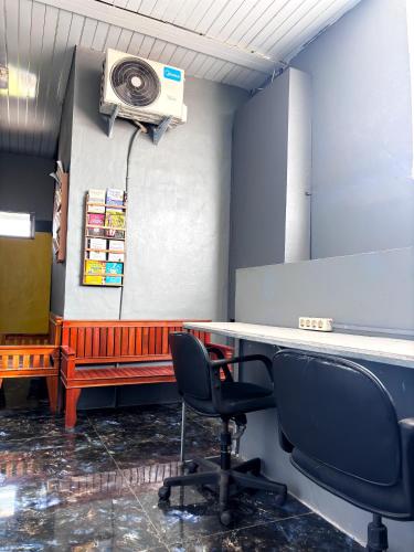 an office with a desk and a speaker on the wall at Kost Harian Semarang Murah in Semarang