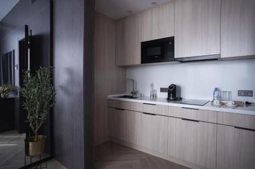 a kitchen with a sink and a microwave at Resident City Hotel in Almaty