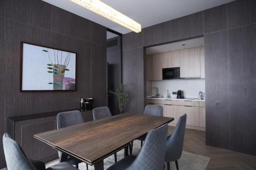 a dining room with a wooden table and chairs at Resident City Hotel in Almaty