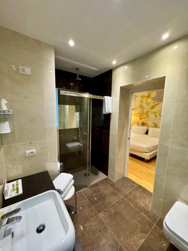 a bathroom with a sink and a shower at Olivi Hotel & Natural Spa in Sirmione