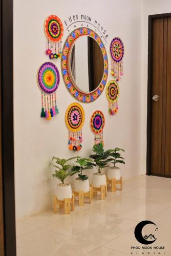 a mirror in a room with plants and decorations at Phoo Moon House Khao Yai บ้านพัก ภู มูน เขาใหญ่ in Ban Bung Toei