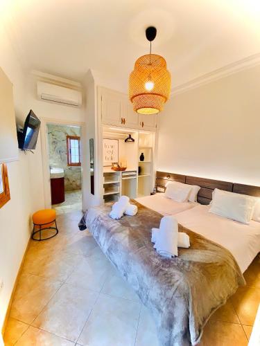 a large bedroom with two beds and a chandelier at Lantia Rooftop House in Arrecife