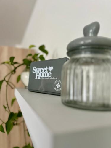 a jar on a shelf with a sign on it at Apartmán Torysa in Prešov