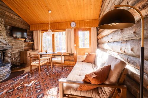 a living room with a couch and a table at Holiday In Lapland - Pikkurakka 4 A 3 in Levi