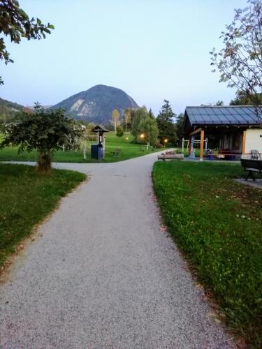 a gravel path in a park with a building at A Casa mia in Bieno