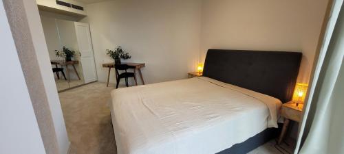 a bedroom with a bed and two tables and chairs at Pinea Apartments in Pobierowo