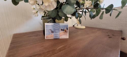 a vase sitting on a table with a vase with flowers at Pinea Apartments in Pobierowo